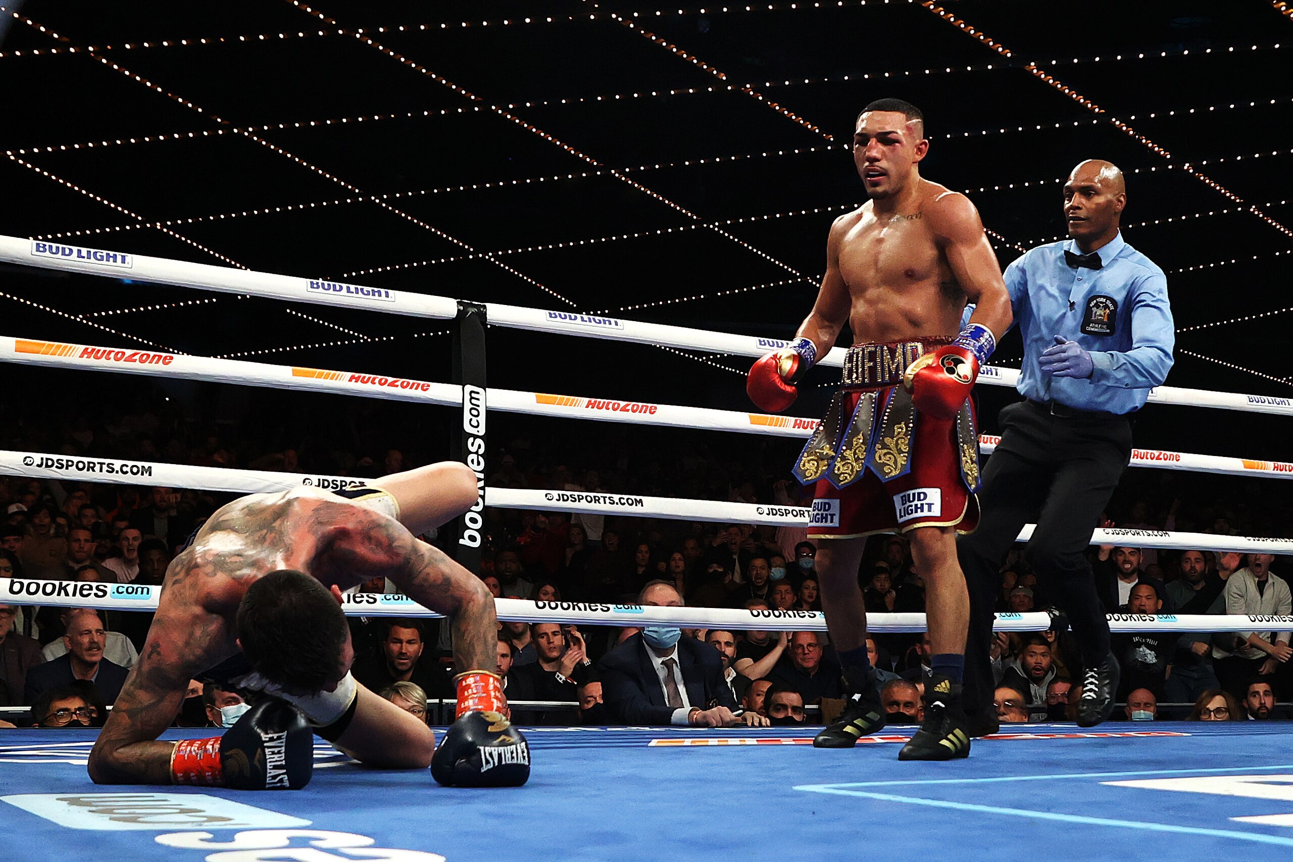 NEW YORK, NEW YORK - NOVEMBER 27:  Teofimo Lopez knocks down George Kambosos in the tenth round during their championship bout for Lopez’s Undisputed Lightweight title at The Hulu Theater at Madison Square Garden on November 27, 2021 in New York, New York