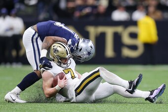NEW ORLEANS, LOUISIANA - DECEMBER 02: Taysom Hill #7 of the New Orleans Saints is sacked by Micah Parsons #11 of the Dallas Cowboys in the fourth quarter of the game at Caesars Superdome on December 02, 2021 in New Orleans, Louisiana. (Photo by Jonathan B