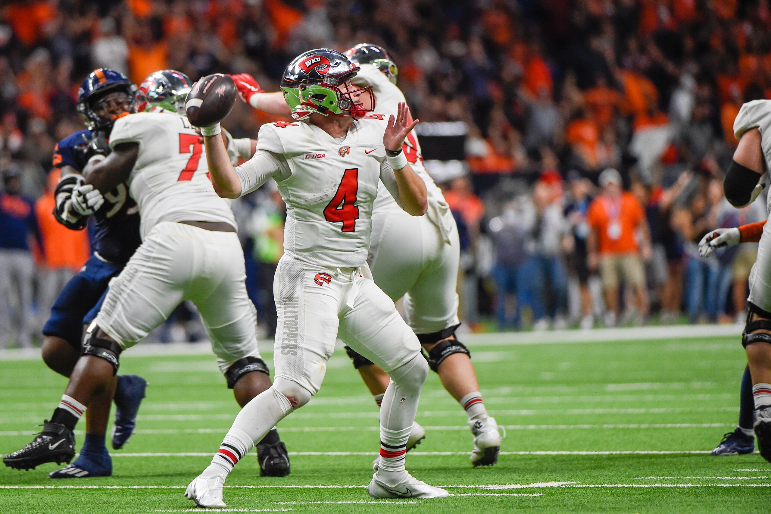 SAN ANTONIO, TX - DECEMBER 03: Western Kentucky Hilltoppers quarterback Bailey Zappe (4) looks to throw downfield during the football game between the Western Kentucky Hilltoppers and UTSA Roadrunners at the Alamodome on December 3, 2021 in San Antonio, T