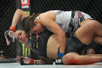 LAS VEGAS, NV - DECEMBER 11: (R-L) Julianna Peña attempts to submit Amanda Nunes in their womans bantamweight title fight during the UFC 269 on December 11, 2021, at T-Mobile Arena in Las Vegas, NV. (Photo by Louis Grasse/PxImages/Icon Sportswire via Gett