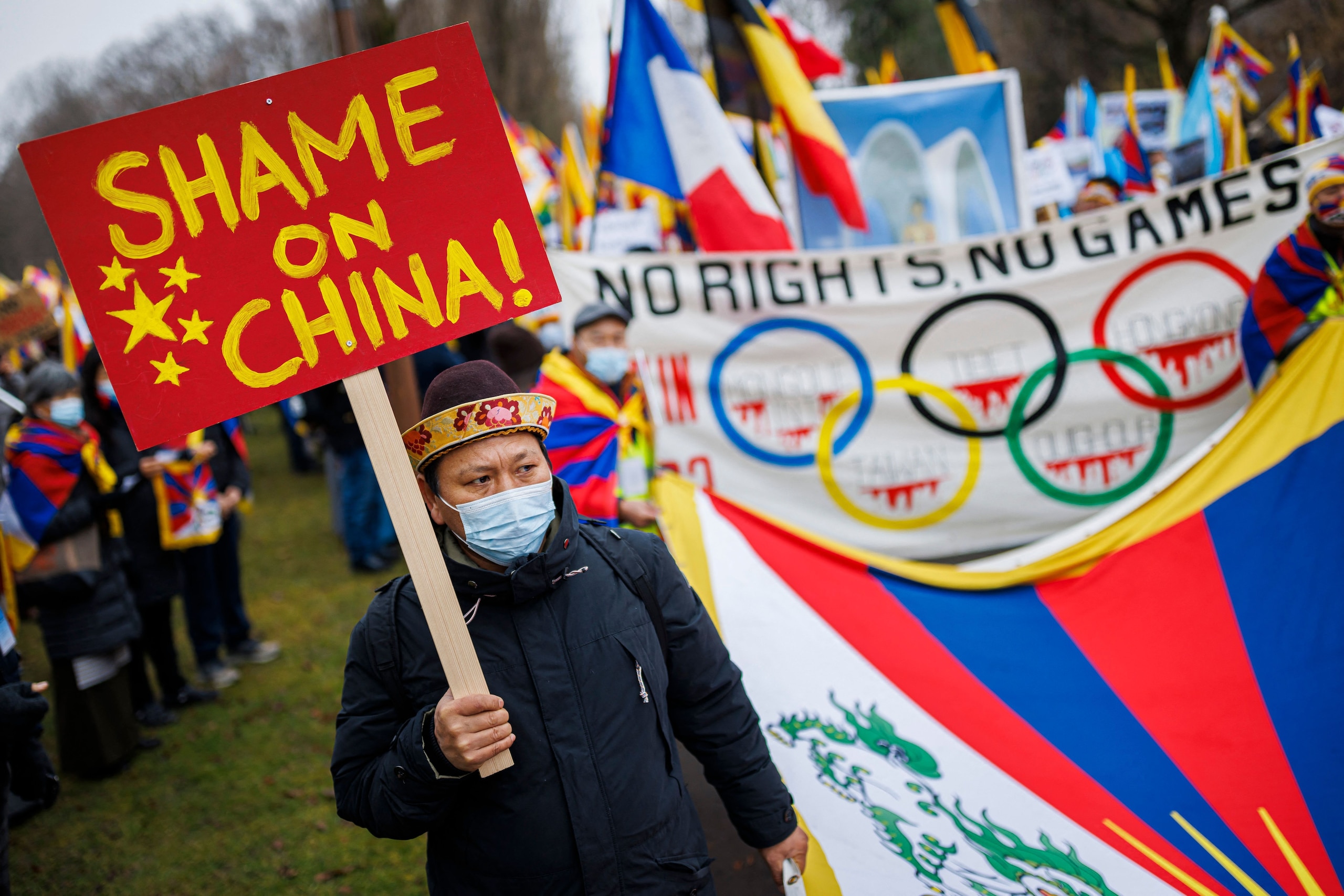 A protester holds a placard reading 'Shame on China' during a   protest march gathering Tibetans from the International Olympic Committee (IOC) headquarters to the Olympic Museum ahead of the opening of the Beijing 2022 Winter Olympics, in Lausanne on Feb
