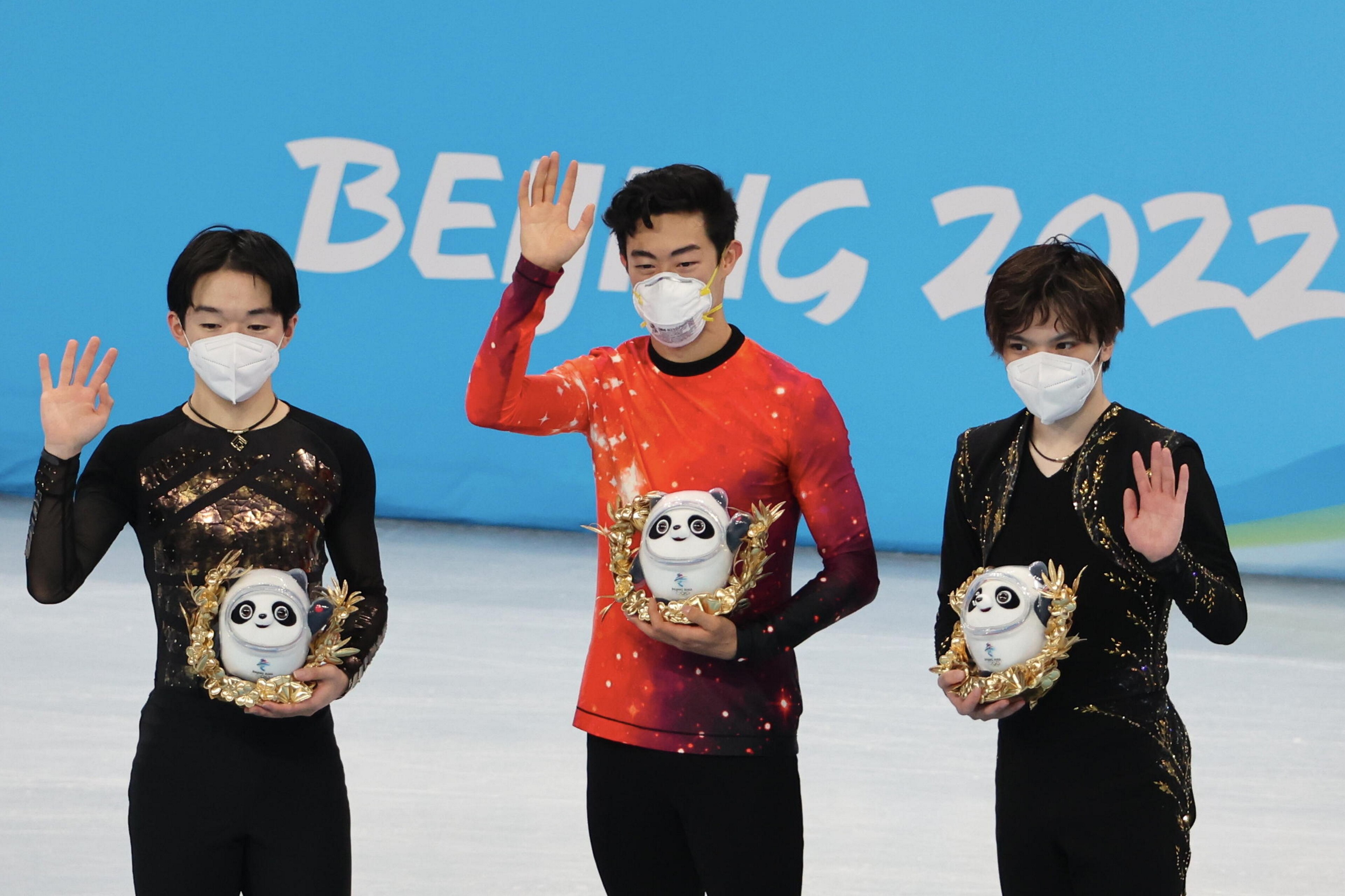 BEIJING, CHINA - FEBRUARY 10: Gold medalist Nathan Chen of Team United States (C), Silver medalist Yuma Kagiyama of Team Japan (L), and Bronze medalist Shoma Uno of Team Japan (R) pose during the Men Single Skating flower ceremony on day six of the Beijin