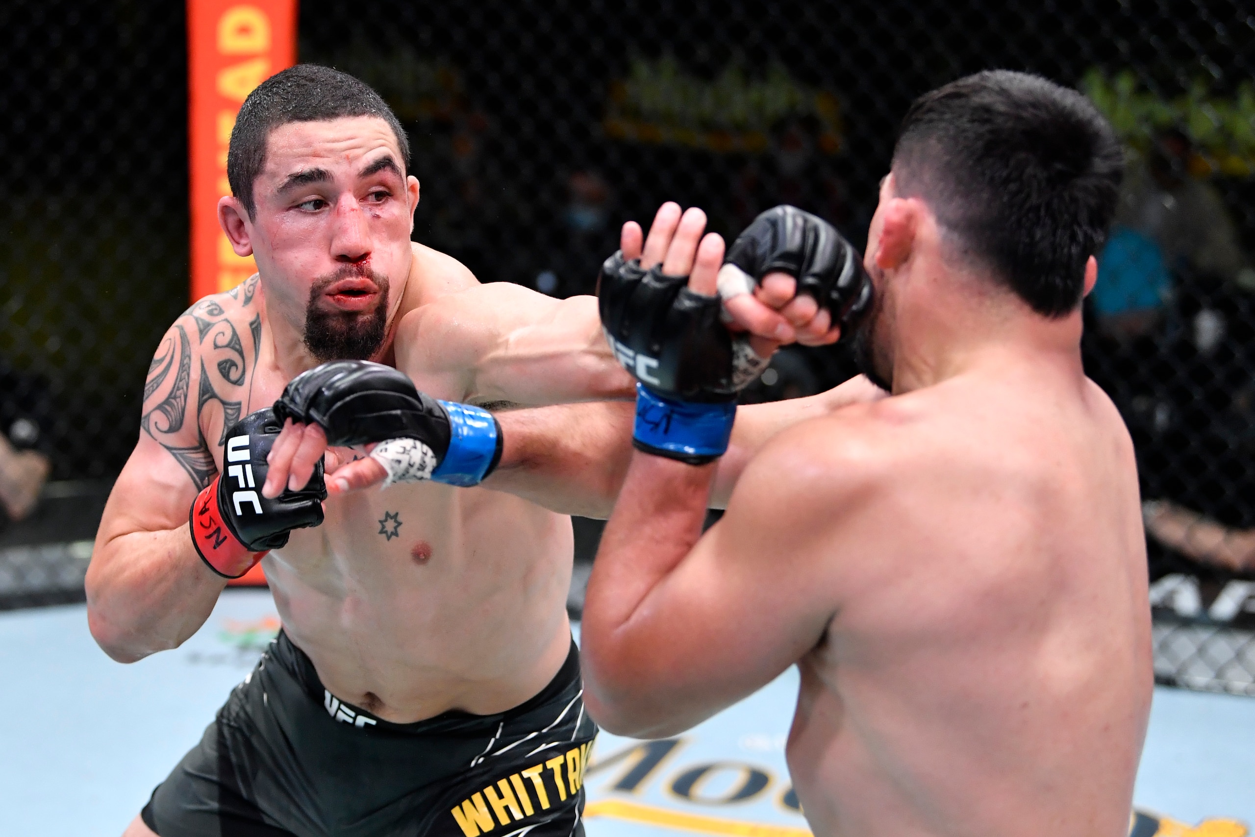 LAS VEGAS, NEVADA - APRIL 17:  In this handout photo, (L-R) Robert Whittaker of Australia punches Kelvin Gastelum in a middleweight fight during the UFC Fight Night event at UFC APEX on April 17, 2021 in Las Vegas, Nevada. (Photo by Chris Unger/Zuffa LLC)