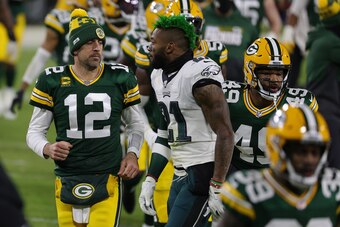 GREEN BAY, WISCONSIN - DECEMBER 06: Aaron Rodgers #12 of the Green Bay Packers speaks with Jalen Mills #21 of the Philadelphia Eagles at halftime during a game at Lambeau Field on December 06, 2020 in Green Bay, Wisconsin.  The Packers defeated the Eagles