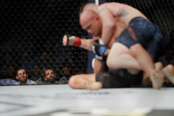 Covington (top) works for position against Lawler