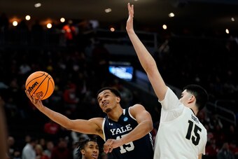 Zach Edey (right) defends a shot by EJ Jarvis