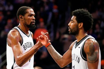 NEW YORK, NEW YORK - APRIL 06: Kevin Durant #7 and Kyrie Irving #11 of the Brooklyn Nets react during the second half against the New York Knicks at Madison Square Garden on April 06, 2022 in New York City. The Nets won 110-98. NOTE TO USER: User expressl