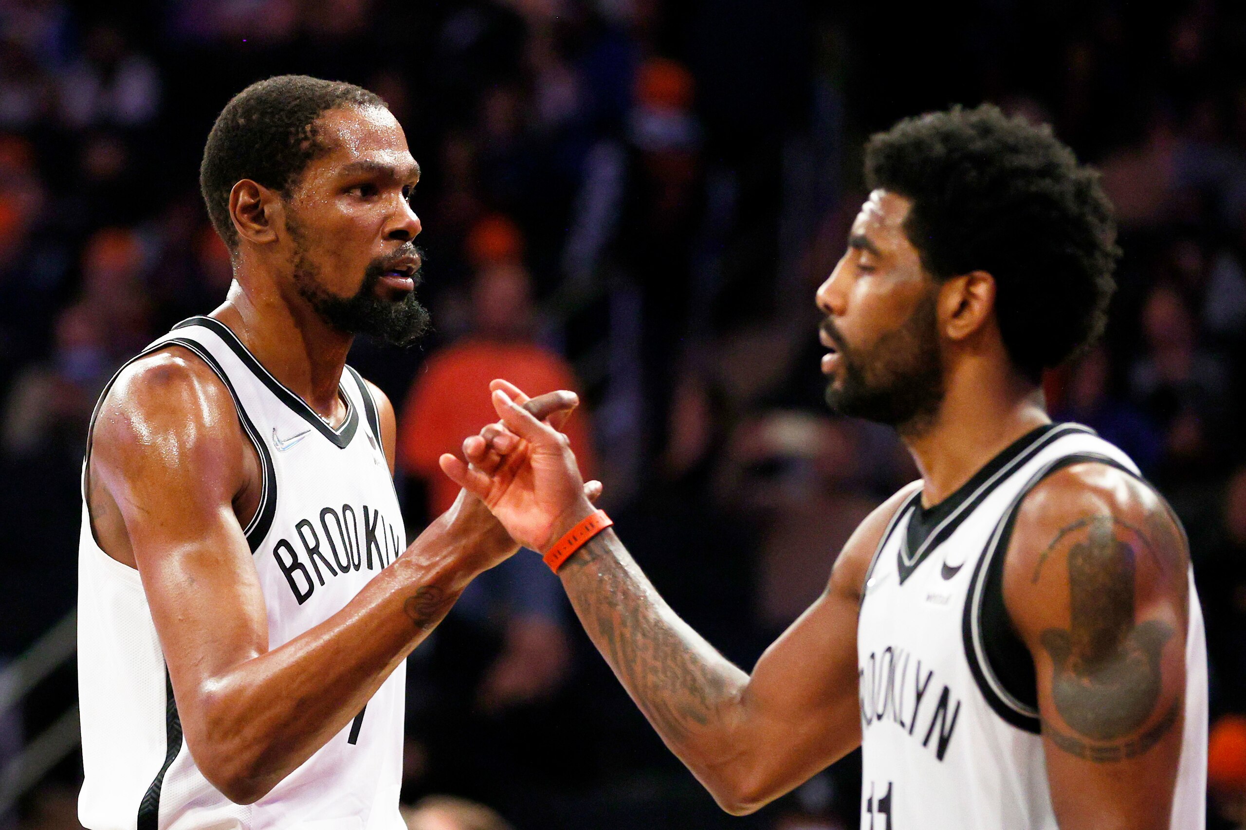 NEW YORK, NEW YORK - APRIL 06: Kevin Durant #7 and Kyrie Irving #11 of the Brooklyn Nets react during the second half against the New York Knicks at Madison Square Garden on April 06, 2022 in New York City. The Nets won 110-98. NOTE TO USER: User expressl
