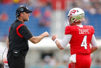 BOCA RATON, FLORIDA - DECEMBER 18: Head coach Tyson Helton of the Western Kentucky Hilltoppers fist bumps Bailey Zappe #4 against the Appalachian State Mountaineers during the second half of the RoofClaim.com Boca Raton Bowl at FAU Stadium on December 18,