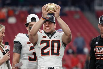 GLENDALE, AZ - JANUARY 01:  Oklahoma State Cowboys linebacker Malcolm Rodriguez (20) holds the Fiesta Bowl trophy after the Fiesta Bowl college football game between the Notre Dame Fighting Irish and the Oklahoma State Cowboys on January 1, 2022 at State 