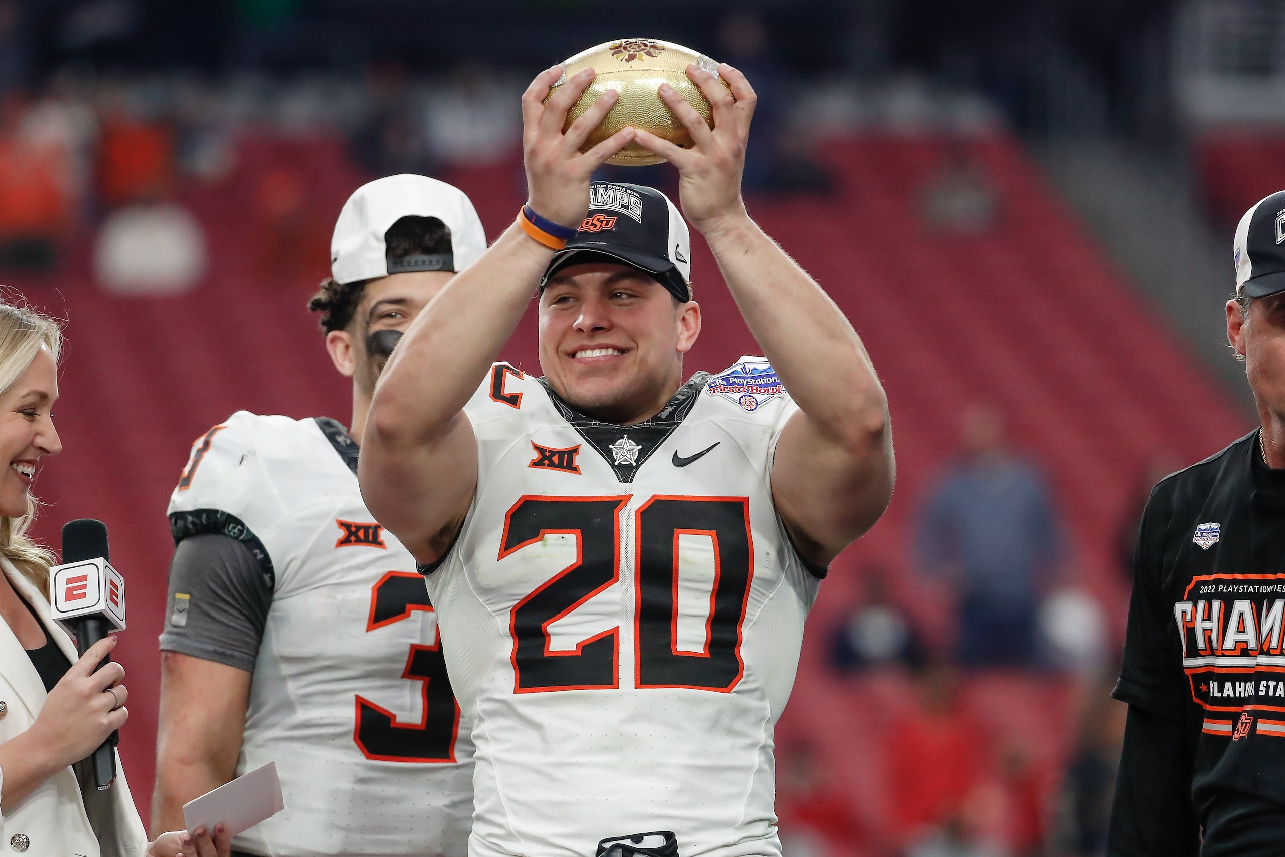 GLENDALE, AZ - JANUARY 01:  Oklahoma State Cowboys linebacker Malcolm Rodriguez (20) holds the Fiesta Bowl trophy after the Fiesta Bowl college football game between the Notre Dame Fighting Irish and the Oklahoma State Cowboys on January 1, 2022 at State 