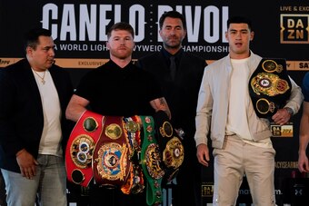 Alvarez (second from left) and Bivol hold their titles