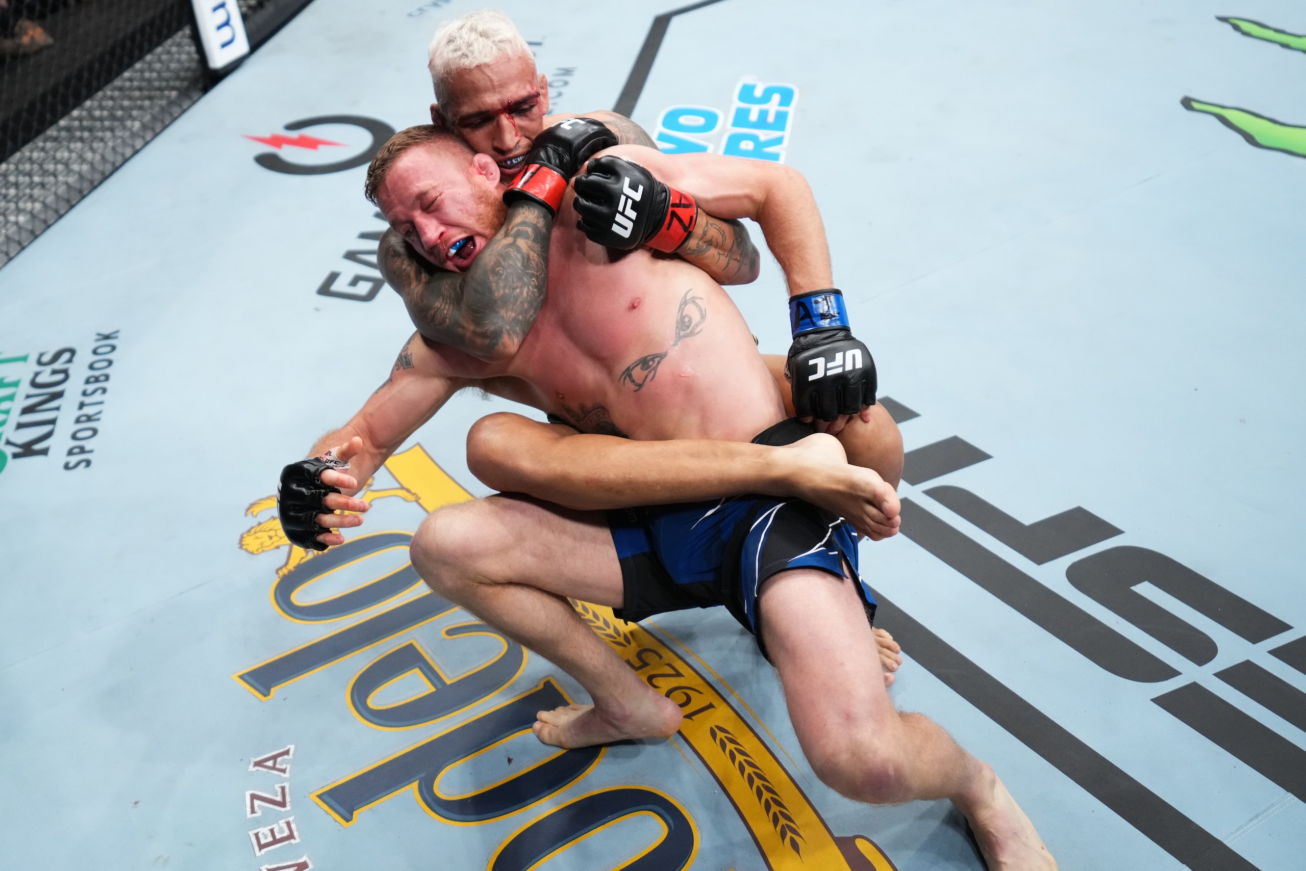 PHOENIX, ARIZONA - MAY 07: (R-L) Charles Oliveira of Brazil secures a rear choke submission against Justin Gaethje in the UFC lightweight championship fight during the UFC 274 event at Footprint Center on May 07, 2022 in Phoenix, Arizona. (Photo by Chris 