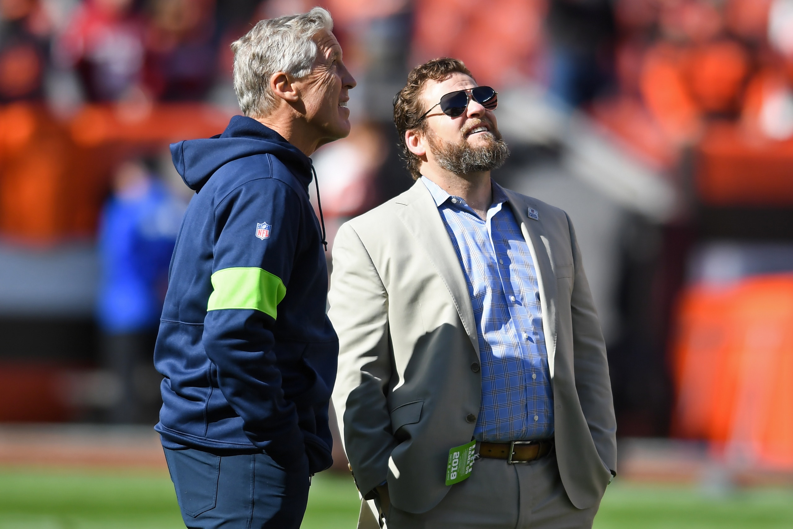 CLEVELAND, OH - OCTOBER 13, 2019: General manager John Schneider of the Seattle Seahawks talks with head coach Pete Carroll prior to a game against the Cleveland Browns on October 13, 2019 at FirstEnergy Stadium in Cleveland, Ohio. Seattle won 32-28. (Pho CLEVELAND, OH - OCTOBER 13, 2019: General manager John Schneider of the Seattle Seahawks talks with head coach Pete Carroll prior to a game against the Cleveland Browns on October 13, 2019 at FirstEnergy Stadium in Cleveland, Ohio. Seattle won 32-28. (Pho