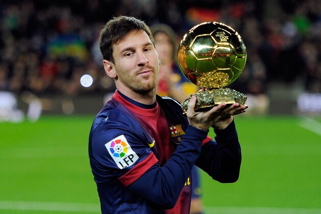 BARCELONA, SPAIN - JANUARY 16: Lionel Messi of Barcelona FC offers his 4th ballon d'or to the audience prior to the Copa del Rey Quarter Final match between Barcelona FC and Malaga CF at Camp Nou on January 16, 2013 in Barcelona, Spain.  (Photo by Gonzalo Arroyo Moreno/Getty Images)