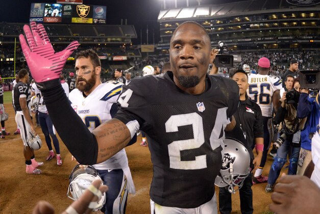 Oct 6, 2013; Oakland, CA, USA; Oakland Raiders safety Charles Woodson (24) reacts at the end of the game against the San Diego Chargers at O.co Coliseum. The Raiders defeated the Chargers 27-17. Mandatory Credit: Kirby Lee-USA TODAY Sports