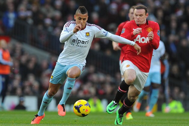 MANCHESTER, ENGLAND - DECEMBER 21:  Ravel Morrison of West Ham United competes with Wayne Rooney of Manchester United during the Barclays Premier League match between Manchester United and West Ham United at Old Trafford on December 21, 2013 in Manchester, England.  (Photo by Stu Forster/Getty Images)