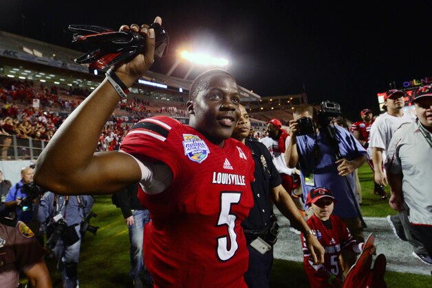 Dec 28, 2013; Orlando, FL, USA; Louisville Cardinals quarterback Teddy Bridgewater (5) celebrates after the Russell Athletic Bowl against the Miami Hurricanes at Florida Citrus Bowl Stadium. Mandatory Credit: David Manning-USA TODAY Sports