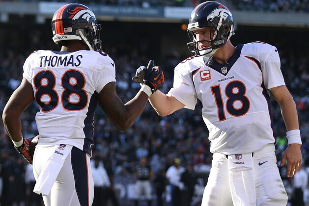 Dec 29, 2013; Oakland, CA, USA; Denver Broncos wide receiver Demaryius Thomas (88) celebrates with quarterback Peyton Manning (18) after scoring a touchdown against the Oakland Raiders during the second quarter at O.co Coliseum. Mandatory Credit: Kelley L Cox-USA TODAY Sports Dec 29, 2013; Oakland, CA, USA; Denver Broncos wide receiver Demaryius Thomas (88) celebrates with quarterback Peyton Manning (18) after scoring a touchdown against the Oakland Raiders during the second quarter at O.co Coliseum. Mandatory Credit: Kelley L Cox-USA TODAY Sports