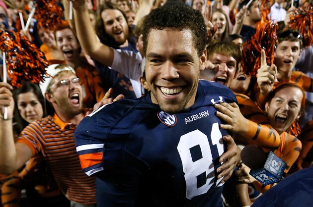 AUBURN, AL - SEPTEMBER 14:  C.J. Uzomah #81 of the Auburn Tigers celebrates with fans after their 24-20 win over the Mississippi State Bulldogs at Jordan-Hare Stadium on September 14, 2013 in Auburn, Alabama.  Uzomah caught the go-ahead touchdown in the final seconds against Mississippi State.  (Photo by Kevin C. Cox/Getty Images)