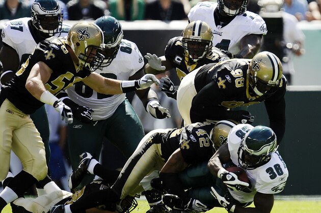 PHILADELPHIA - SEPTEMBER 20: Brian Westbrook #36 of the Philadelphia Eagles is tackled by Darren Sharper #42 and Sedrick Ellis #98 of the New Orleans Saints during their game at Lincoln Financial Field on September 20, 2009 in Philadelphia, Pennsylvania.  (Photo by Jeff Zelevansky/Getty Images)