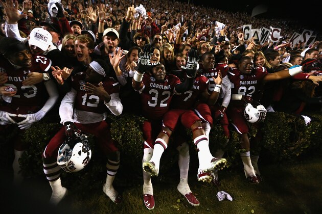 COLUMBIA, SC - NOVEMBER 30:  The South Carolina Gamecocks celebrate with students after a 31-17 victory over the Clemson Tigers after their game at Williams-Brice Stadium on November 30, 2013 in Columbia, South Carolina.  (Photo by Streeter Lecka/Getty Images)