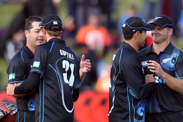 QUEENSTOWN, NEW ZEALAND - JANUARY 01:  (L-R) Jesse Ryder of New Zealand is congratulated by Martin Guptill and Ross Taylor congratulates Corey Anderson on his world record 100 during game three of the One Day International Series between New Zealand and the West Indies at Queenstown Events Centre on January 1, 2014 in Queenstown, New Zealand.  (Photo by Rob Jefferies/Getty Images)