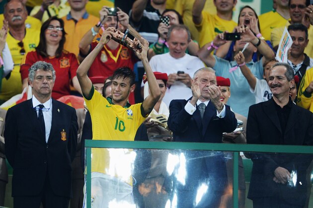 RIO DE JANEIRO, BRAZIL - JUNE 30:  Neymar of Brazil celebrates with the adidas Bronze Boot award as FIFA President Sepp Blatter (R) looks on after the FIFA Confederations Cup Brazil 2013 Final match between Brazil and Spain at Maracana on June 30, 2013 in Rio de Janeiro, Brazil.  (Photo by Michael Regan/Getty Images)