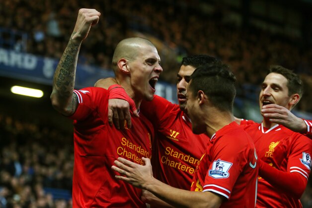 LONDON, ENGLAND - DECEMBER 29:  (L-R) Martin Skrtel of Liverpool celebrates with teammates Luis Suarez,  Philippe Coutinho and Joe Allen after scoring the opening goal during the Barclays Premier League match between Chelsea and Liverpool at Stamford Bridge on December 29, 2013 in London, England.  (Photo by Clive Rose/Getty Images)