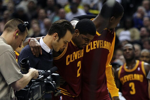 Dec 31, 2013; Indianapolis, IN, USA;  Cleveland Cavaliers point guard Kyrie Irving (2) is helped off the court after being injured during the third quarter against the Indiana Pacers at Bankers Life Fieldhouse. The Pacers won 91-76.  Mandatory Credit: Pat Lovell-USA TODAY Sports
