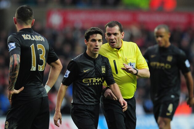 SWANSEA, WALES - JANUARY 01:  Manchester City player Jesus Navas is spoken to by referee Phil Dowd during the Barclays Premier League match between Swansea City and Manchester City at Liberty Stadium on January 1, 2014 in Swansea, Wales.  (Photo by Stu Forster/Getty Images)
