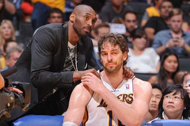 LOS ANGELES, CA - APRIL 28: Kobe Bryant #24 of the Los Angeles Lakers greets teammate Pau Gasol #16 on the bench as their team plays against the San Antonio Spurs in Game Four of the Western Conference Quarterfinals during the 2013 NBA Playoffs at Staples Center on April 28, 2013 in Los Angeles, California.  NOTE TO USER: User expressly acknowledges and agrees that, by downloading and/or using this Photograph, user is consenting to the terms and conditions of the Getty Images License Agreement. Mandatory Copyright Notice: Copyright 2013 NBAE (Photo by Andrew D. Bernstein/NBAE via Getty Images)