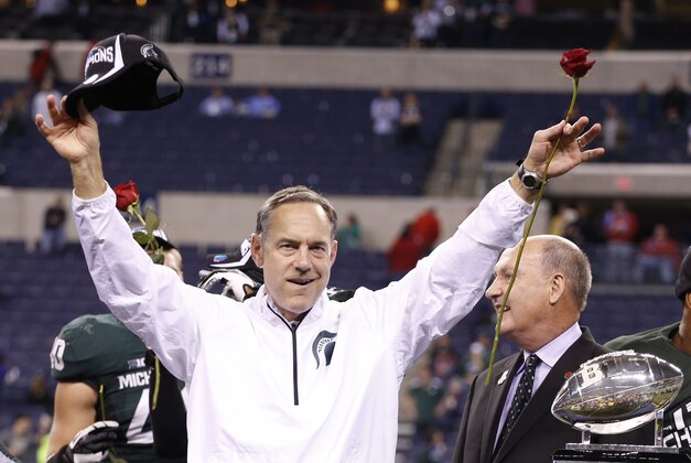 Dec 7, 2013; Indianapolis, IN, USA; Michigan State Spartans coach Mark Dantonio celebrates defeating the Ohio State Buckeyes during the Big Ten Championship game at Lucas Oil Stadium. Michigan State defeats Ohio State 34-24.  Mandatory Credit: Brian Spurlock-USA TODAY Sports