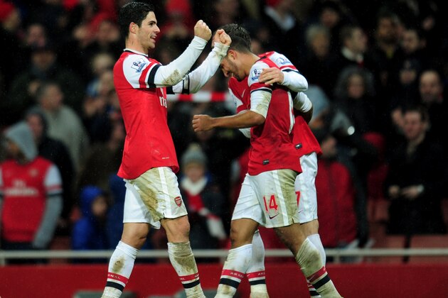LONDON, ENGLAND - JANUARY 01:  Theo Walcott of Arsenal (14) celebrates with Mikel Arteta (L) as he scores their second goal during the Barclays Premier League match between Arsenal and Cardiff City at Emirates Stadium on January 1, 2014 in London, England.  (Photo by Shaun Botterill/Getty Images)