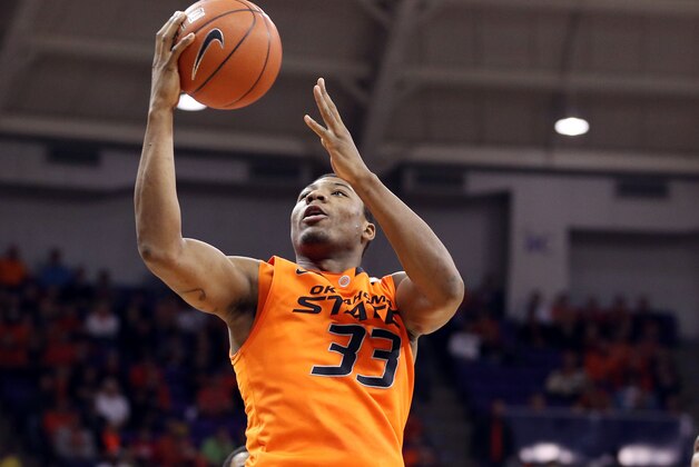 Feb 27, 2013; Fort Worth, TX, USA; Oklahoma State Cowboys guard Marcus Smart (33) shoots against TCU Horned Frogs forward Devonta Abron (23) during the first half at the Daniel-Meyer Coliseum. Mandatory Credit: Jim Cowsert-USA TODAY Sports