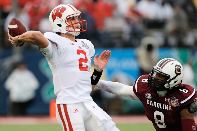 ORLANDO, FL - JANUARY 01:  Joel Stave#2 of the Wisconsin Badgers looks to pass in the first half against Kaiwan Lewis #8 of the South Carolina Gamecocks during the Capital One Bowl on January 1, 2014 in Orlando, Florida.  (Photo by Scott Halleran/Getty Images)