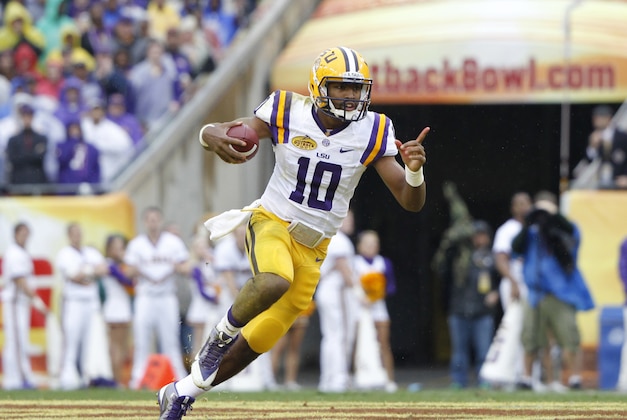 Jan 1, 2014; Tampa, Fl, USA; LSU Tigers quarterback Anthony Jennings (10) points as he runs out of the pocket against the Iowa Hawkeyes during the first half at Raymond James Stadium. Mandatory Credit: Kim Klement-USA TODAY Sports