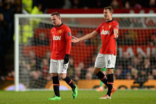 MANCHESTER, ENGLAND - JANUARY 01: Wayne Rooney of Manchester United and his team-mate Jonny Evans react after conceding a second goal during the Barclays Premier League match between Manchester United and Tottenham Hotspur at Old Trafford on January 1, 2014 in Manchester, England. (Photo by Michael Regan/Getty Images) MANCHESTER, ENGLAND - JANUARY 01: Wayne Rooney of Manchester United and his team-mate Jonny Evans react after conceding a second goal during the Barclays Premier League match between Manchester United and Tottenham Hotspur at Old Trafford on January 1, 2014 in Manchester, England. (Photo by Michael Regan/Getty Images)