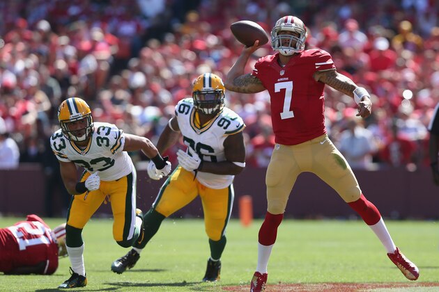 SAN FRANCISCO, CA - SEPTEMBER 08:  Quarterback Colin Kaepernick #7 of the San Francisco 49ers is pursued by Micah Hyde #33 and Mike Neal #96 of the Green Bay Packers at Candlestick Park on September 8, 2013 in San Francisco, California.  (Photo by Jeff Gross/Getty Images)