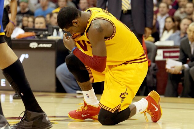 CLEVELAND, OH - DECEMBER 29: Kyrie Irving #2 of the Cleveland Cavaliers kneels on the court after being hit in the face in the second quarter against the Golden State Warriors at Quicken Loans Arena on December 29, 2013 in Cleveland, Ohio. NOTE TO USER: User expressly acknowledges and agrees that, by downloading and/or using this photograph, user is consenting to the terms and conditions of the Getty Images License Agreement.  (Photo by Mike Lawrie/Getty Images)