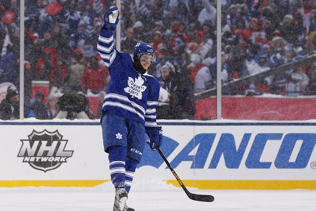 Jan 1, 2014; Ann Arbor, MI, USA; Toronto Maple Leafs center Tyler Bozak (42) celebrates after scoring the game-winning goal in the overtime shootout of the 2014 Winter Classic hockey game against the Detroit Red Wings at Michigan Stadium. Mandatory Credit: Rick Osentoski-USA TODAY Sports