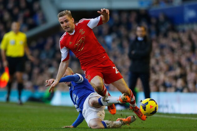 LIVERPOOL, ENGLAND - DECEMBER 29:  Luke Shaw of Southampton is tackled by Steven Naismith of Everton during the Barclays Premier League match between Everton and Southampton at Goodison Park on December 29, 2013 in Liverpool, England.  (Photo by Paul Thomas/Getty Images)
