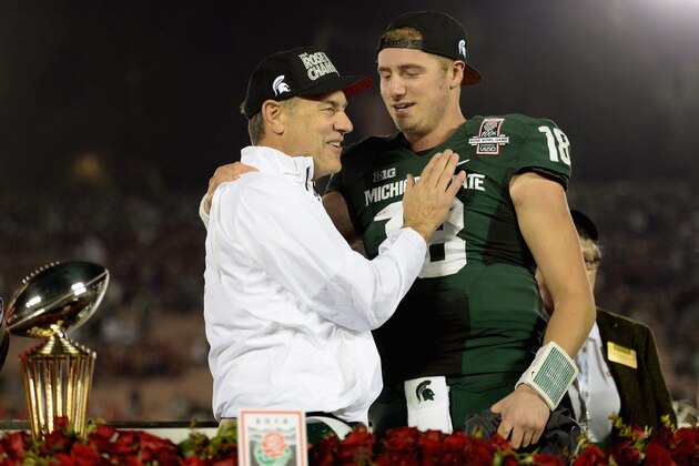 PASADENA, CA - JANUARY 01:  Michigan State Spartans head coach Mark Dantonio and quarterback Connor Cook #18 celebrate with the Rose Bowl Game trophy after defeating the Stanford Cardinal 24-20 in the 100th Rose Bowl Game presented by Vizio at the Rose Bowl on January 1, 2014 in Pasadena, California.  (Photo by Harry How/Getty Images)
