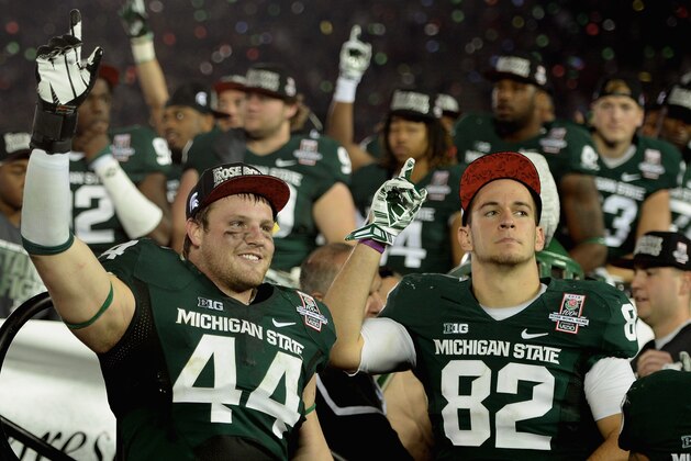 PASADENA, CA - JANUARY 01:  Defensive end Marcus Rush #44 and tight end Josiah Price #82 of the Michigan State Spartans celebrate after defeating the Stanford Cardinal 24-20 in the 100th Rose Bowl Game presented by Vizio at the Rose Bowl on January 1, 2014 in Pasadena, California.  (Photo by Harry How/Getty Images)