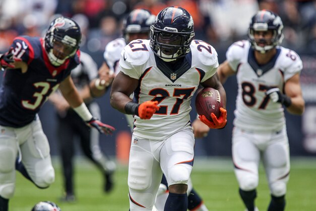 Dec 22, 2013; Houston, TX, USA; Denver Broncos running back Knowshon Moreno (27) rushes during the first quarter against the Houston Texans at Reliant Stadium. Mandatory Credit: Troy Taormina-USA TODAY Sports