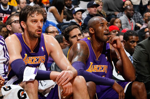 ATLANTA, GA - DECEMBER 16:  Pau Gasol #16 and Kobe Bryant #24 of the Los Angeles Lakers look on during the game against the Atlanta Hawks at Philips Arena on December 16, 2013 in Atlanta, Georgia.  NOTE TO USER: User expressly acknowledges and agrees that, by downloading and or using this photograph, User is consenting to the terms and conditions of the Getty Images License Agreement.  (Photo by Kevin C. Cox/Getty Images)