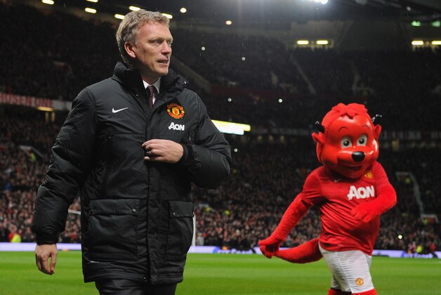 MANCHESTER, ENGLAND - JANUARY 01:  Manchester United Manager David Moyes walks with mascot Fred the Red prior to the Barclays Premier League match between Manchester United and Tottenham Hotspur at Old Trafford on January 1, 2014 in Manchester, England.  (Photo by Michael Regan/Getty Images)