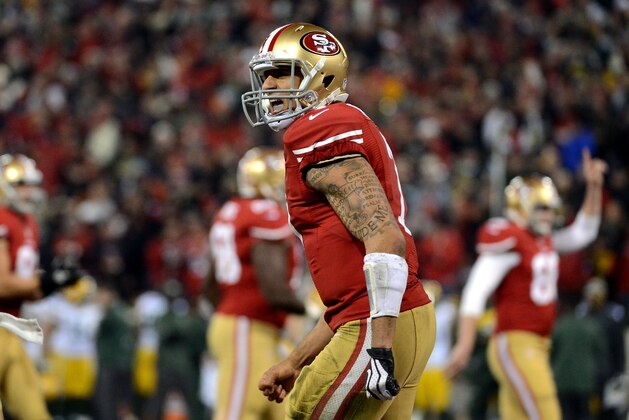 SAN FRANCISCO, CA - JANUARY 12:  Quarterback Colin Kaepernick #7 of the San Francisco 49ers celebrates a touchdown against the Green Bay Packers during the NFC Divisional Playoff Game at Candlestick Park on January 12, 2013 in San Francisco, California.  (Photo by Harry How/Getty Images)