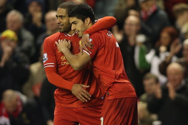LIVERPOOL, ENGLAND - JANUARY 01:  Luis Suarez of Liverpool celebrates with team mate Glen Johnson after scoring the second goal from a free kick during the Barclays Premier League match between Liverpool and Hull City at Anfield on January 1, 2014 in Liverpool, England.  (Photo by Clive Brunskill/Getty Images)