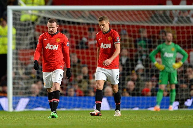 MANCHESTER, ENGLAND - JANUARY 01:  Wayne Rooney of Manchester United and his team-mate Nemanja Vidic (r) react after conceding a second goal during the Barclays Premier League match between Manchester United and Tottenham Hotspur at Old Trafford on January 1, 2014 in Manchester, England.  (Photo by Michael Regan/Getty Images)